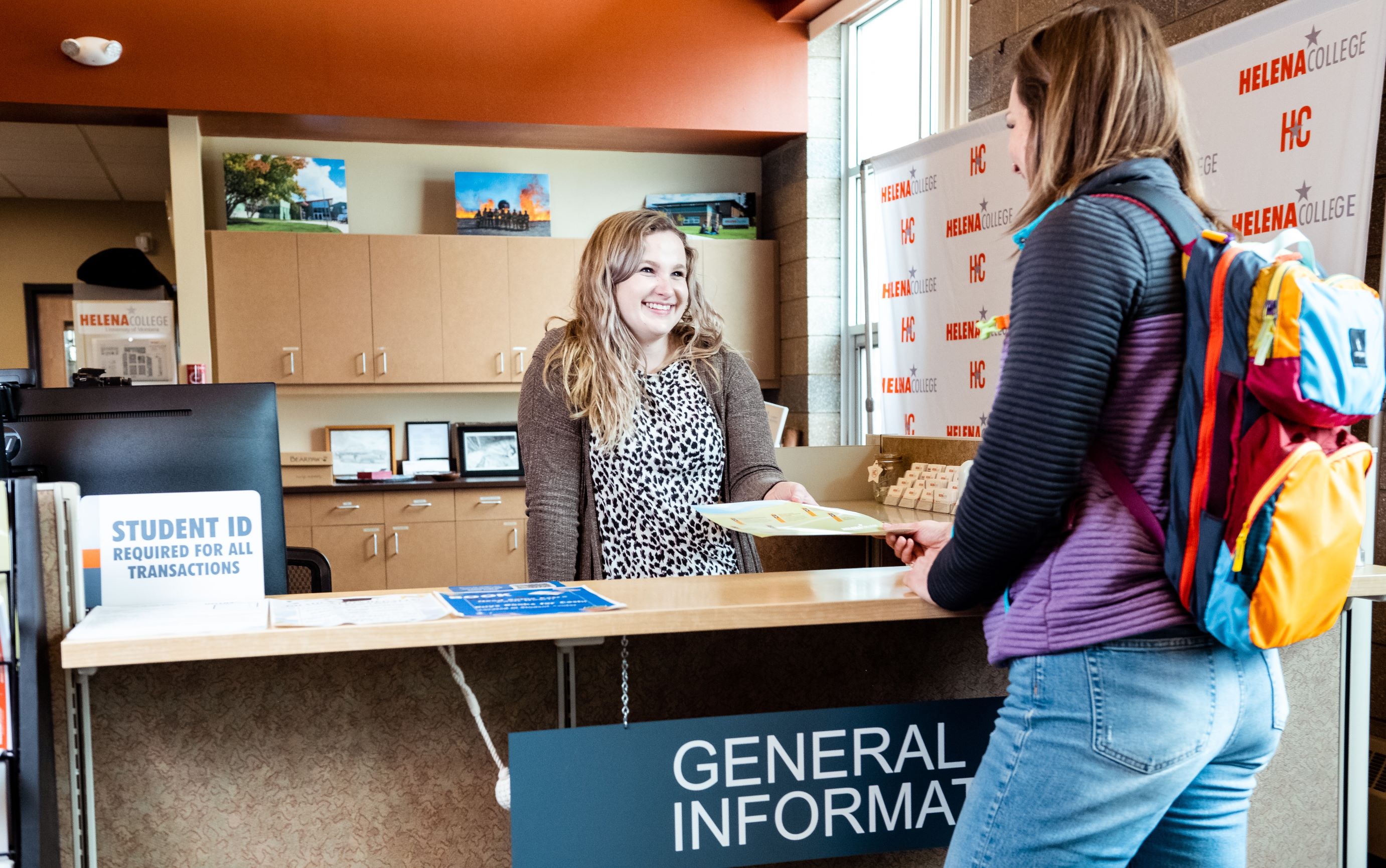 Picture of the Helena College Welcome Center with a student